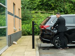 a member of staff charging their electric car Mitsubishi Outlander PHEV at their business premises