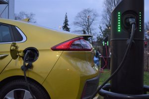 Gold Hyundai IONIQ charging at a Chargemaster black fastpost EV electric vehicle charging point
