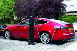 Tesla Model S charging at Chargemaster black fastpost on a pavement